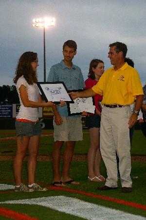 Elizabeth Crute, a top college scholar, receives her scholarship from the chapter during Member Appreciation Night in July.